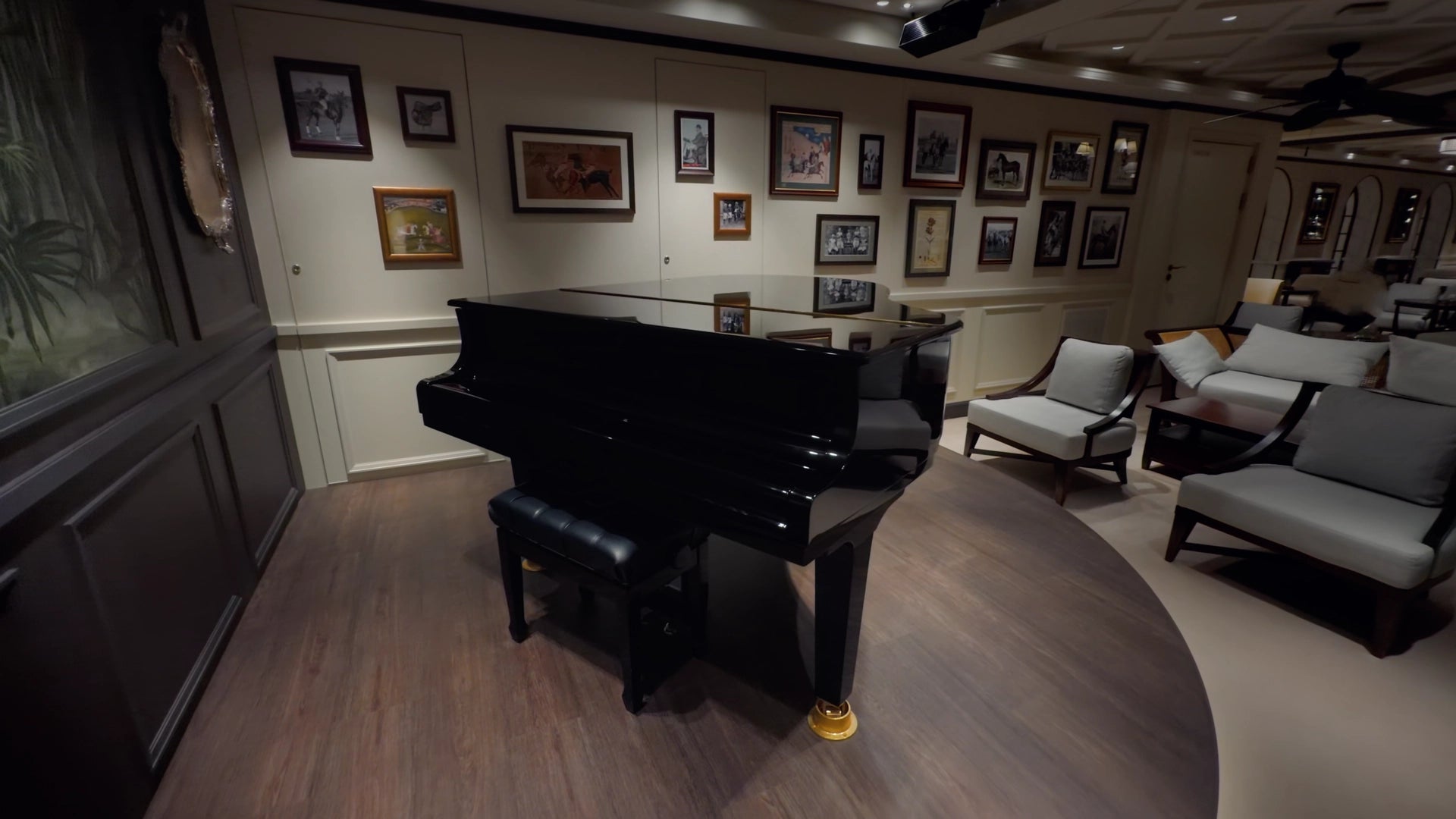 Color Graded Apple Log 2 Footage of a Grand piano in a room with framed pictures on the wall and comfortable seating.
